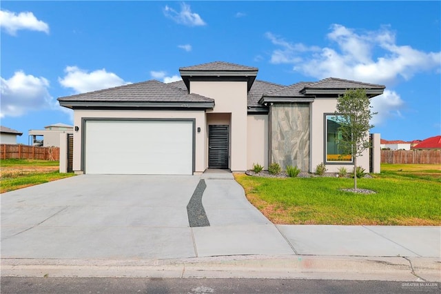 view of front facade featuring a garage and a front lawn