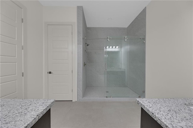 bathroom with tile patterned flooring, vanity, and a shower with shower door