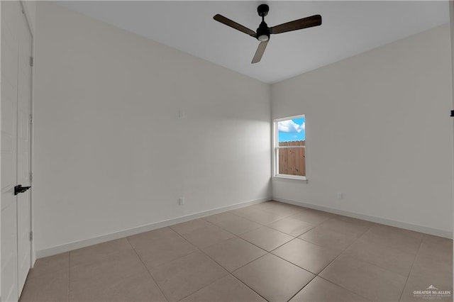 spare room with light tile patterned floors and ceiling fan