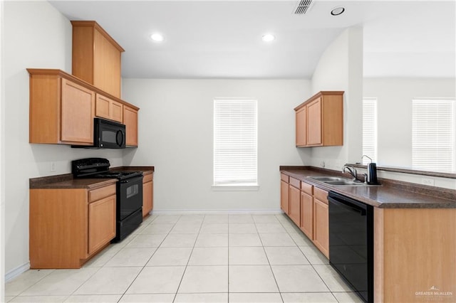 kitchen featuring light tile patterned floors, sink, and black appliances