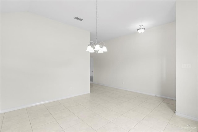 unfurnished room featuring lofted ceiling and a notable chandelier