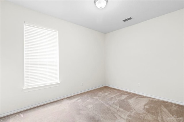 unfurnished room with light carpet