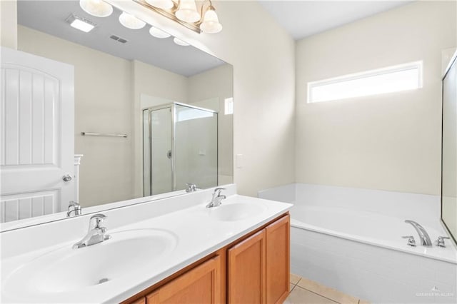 bathroom featuring tile patterned flooring, vanity, and shower with separate bathtub