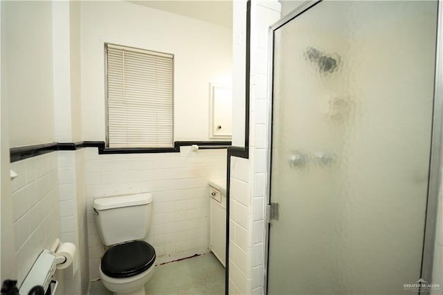 bathroom with toilet, an enclosed shower, and tile walls