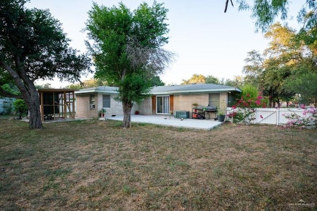 back of house with a patio area, a yard, and central air condition unit