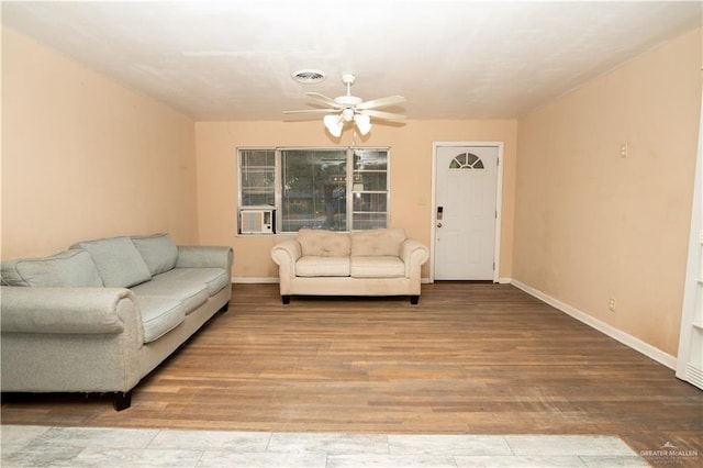 living room featuring hardwood / wood-style flooring and ceiling fan