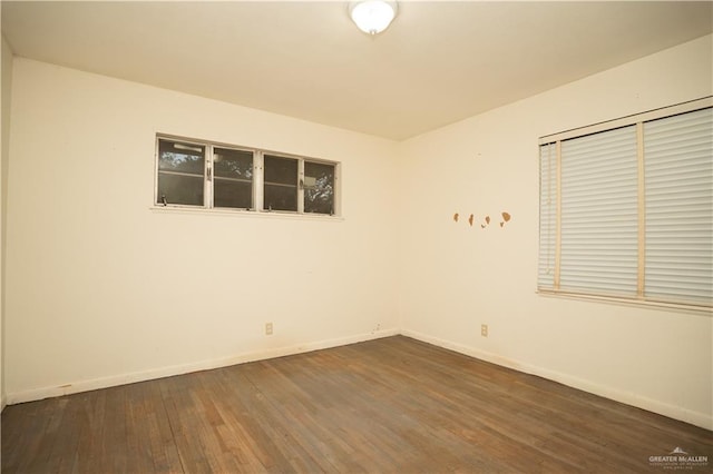 spare room with dark hardwood / wood-style flooring