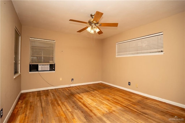 unfurnished room with hardwood / wood-style floors, cooling unit, and ceiling fan