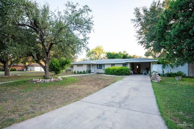 ranch-style house featuring a front yard and a carport