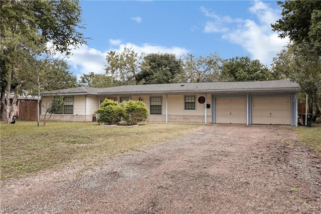 single story home featuring a garage and a front yard