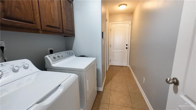 4919 Crown Point St, Edinburg, TX 78541 - washroom featuring cabinet space, washing machine and clothes dryer, light tile patterned flooring, and baseboards