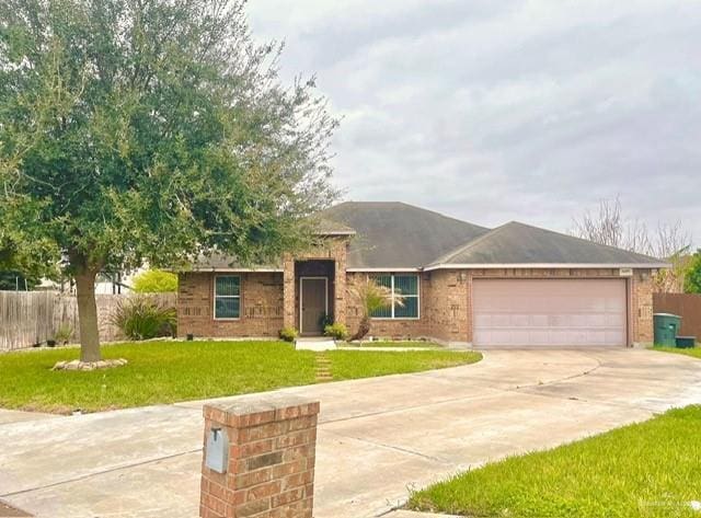 ranch-style house featuring a garage, driveway, a front yard, and fence