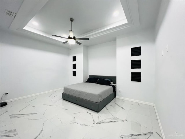 bedroom featuring a tray ceiling and ceiling fan