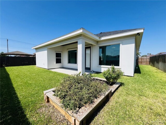 rear view of property with a yard