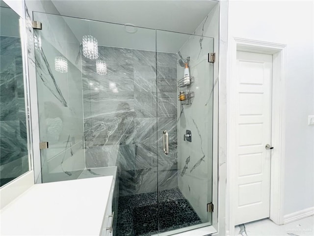 bathroom featuring vanity and a shower with shower door