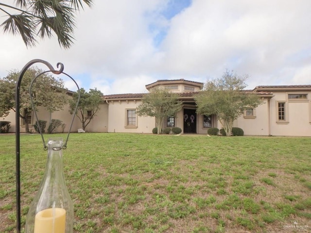 11213 N Fm 88th Blvd, Weslaco, TX 78599 - exterior space featuring a tile roof, a front yard, and stucco siding