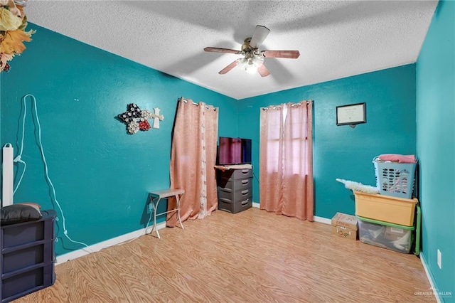 7027 Jo Din St, Edinburg, TX 78542 - office area featuring wood finished floors, ceiling fan, a textured ceiling, and baseboards