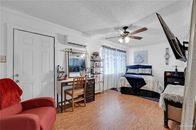 7027 Jo Din St, Edinburg, TX 78542 - bedroom with light wood finished floors, an AC wall unit, a textured ceiling, a ceiling fan, and an office area