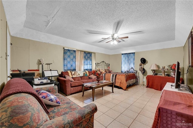 7027 Jo Din St, Edinburg, TX 78542 - living room featuring a textured ceiling, light tile patterned floors, ceiling fan, and a tray ceiling