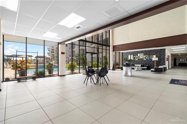 813 Travis St Unit 214, Mission, TX 78572 - community lobby with a wall of windows, a drop ceiling, and a high ceiling
