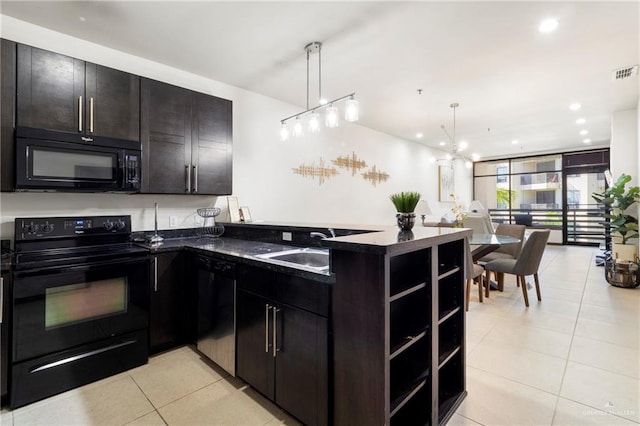 813 Travis St Unit 214, Mission, TX 78572 - kitchen with black appliances, light tile patterned floors, a peninsula, decorative light fixtures, and a sink