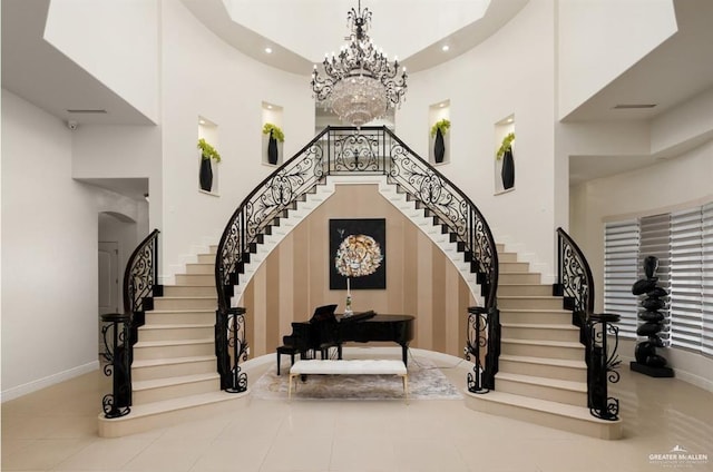 entrance foyer featuring a towering ceiling and a chandelier