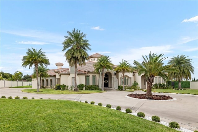 mediterranean / spanish-style house with a front lawn