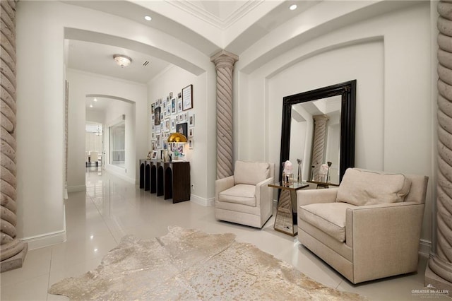 interior space with crown molding, ornate columns, and light tile patterned floors