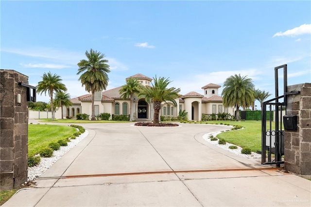 mediterranean / spanish home with a front yard