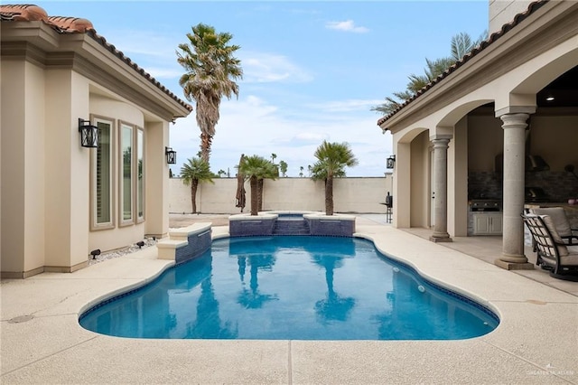 view of swimming pool with a patio and an in ground hot tub