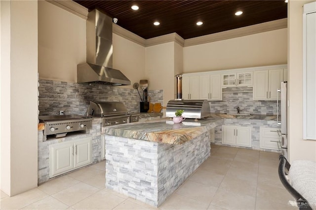 kitchen with white cabinetry, a center island, decorative backsplash, wooden ceiling, and wall chimney exhaust hood