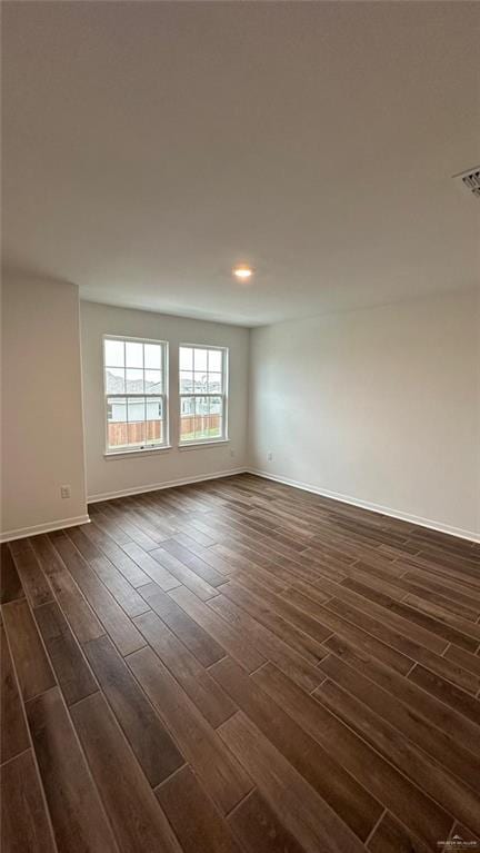 spare room with dark wood-type flooring