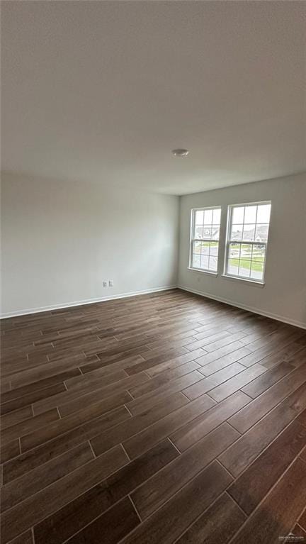 empty room with dark wood-type flooring