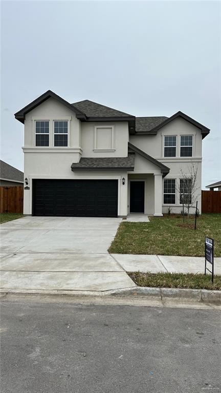 view of front of home featuring a garage and a front yard