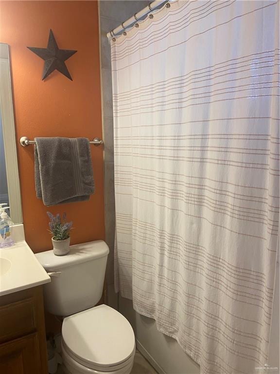 full bathroom with shower / tub combo, vanity, and toilet