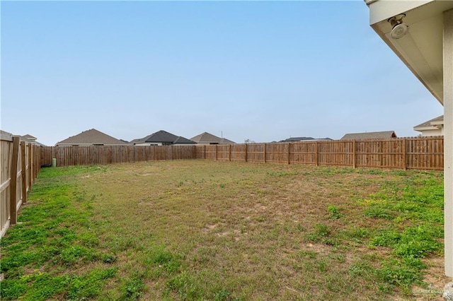 view of yard with a fenced backyard