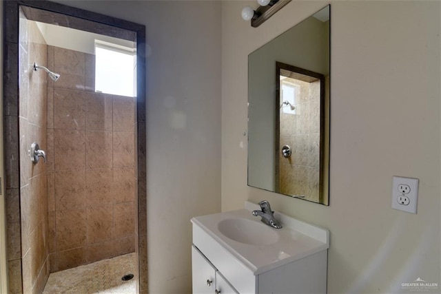 bathroom featuring vanity and tiled shower