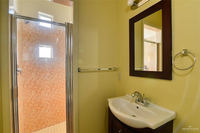 bathroom featuring tile patterned flooring, vanity, and an enclosed shower