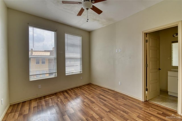 empty room with light hardwood / wood-style floors and ceiling fan