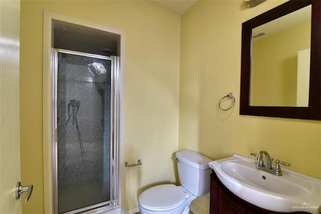 bathroom featuring vanity, toilet, and an enclosed shower