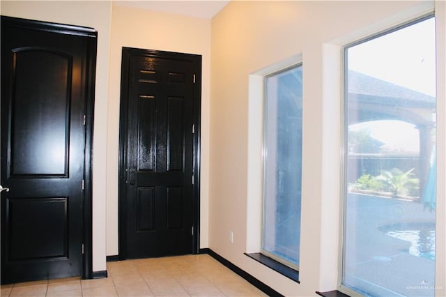 entryway with light tile patterned floors