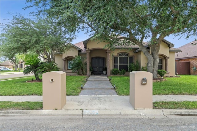 2712 Cornell Ave, Mcallen, TX 78504 - mediterranean / spanish house with fence, a front yard, and stucco siding