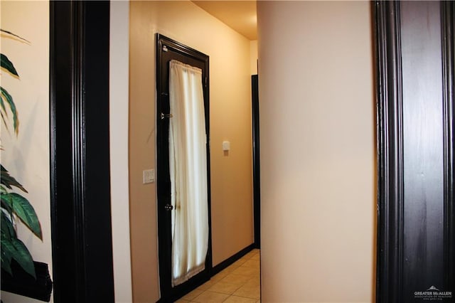 hall featuring light tile patterned flooring