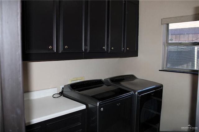 washroom featuring cabinets and independent washer and dryer