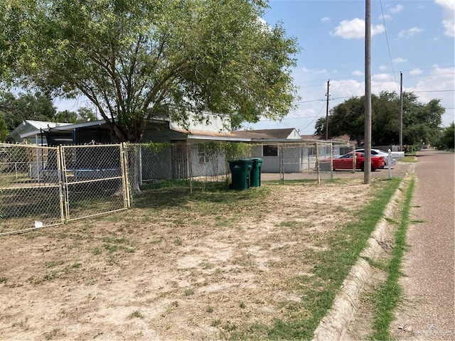 602 E Kelly Ave E, Pharr, TX 78577 - view of yard featuring dirt driveway, a carport, and a gate
