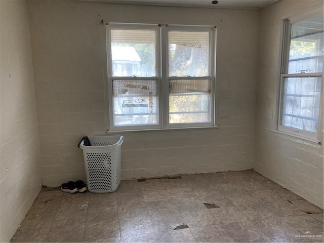 602 E Kelly Ave E, Pharr, TX 78577 - empty room with healthy amount of natural light and concrete block wall