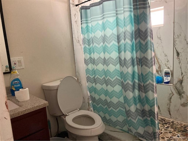 bathroom with vanity, toilet, and walk in shower