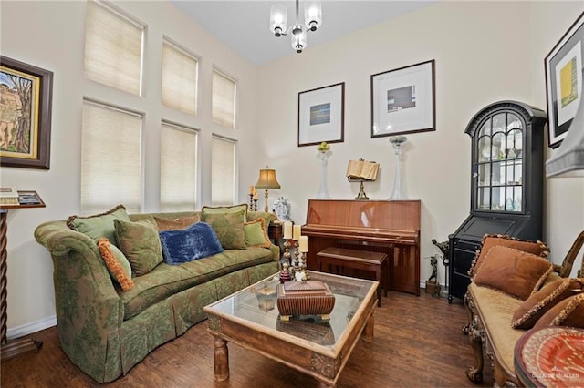 sitting room with dark hardwood / wood-style flooring and an inviting chandelier