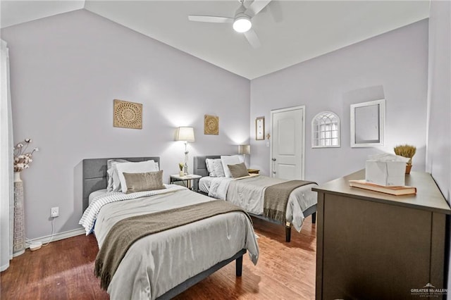 bedroom featuring ceiling fan, wood-type flooring, and lofted ceiling