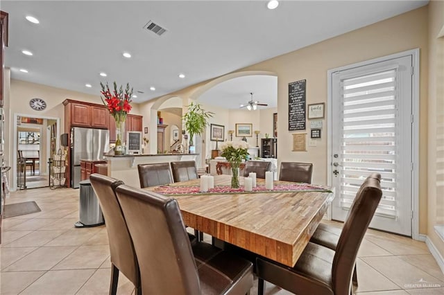 tiled dining room featuring ceiling fan